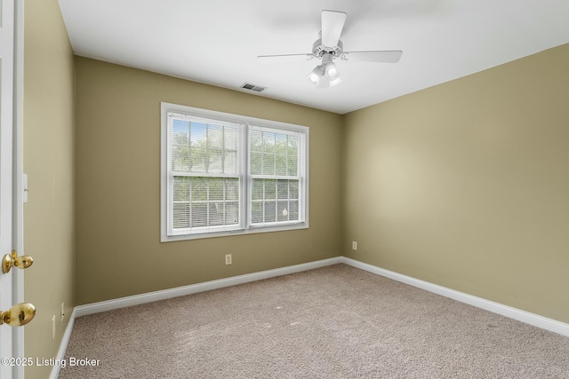 empty room with baseboards, visible vents, and carpet floors