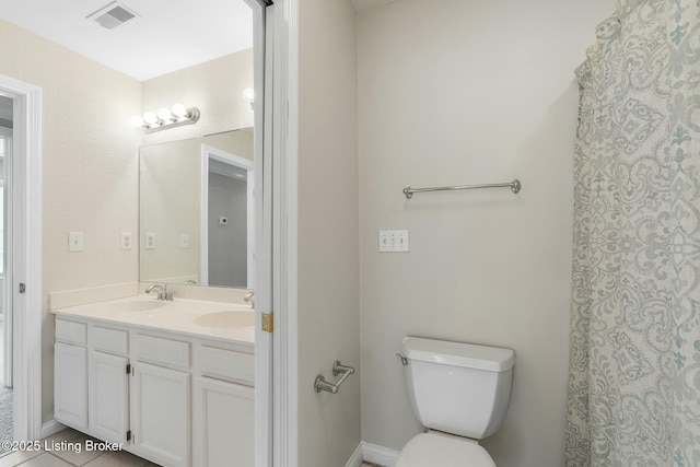 bathroom with visible vents, toilet, double vanity, and a sink