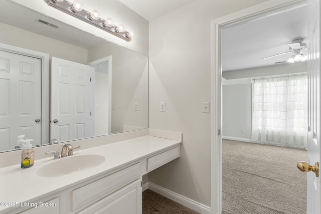 bathroom featuring visible vents, vanity, and baseboards