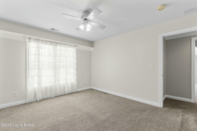 spare room featuring baseboards, visible vents, ceiling fan, and carpet flooring