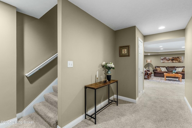 hallway featuring stairway, recessed lighting, carpet flooring, and baseboards