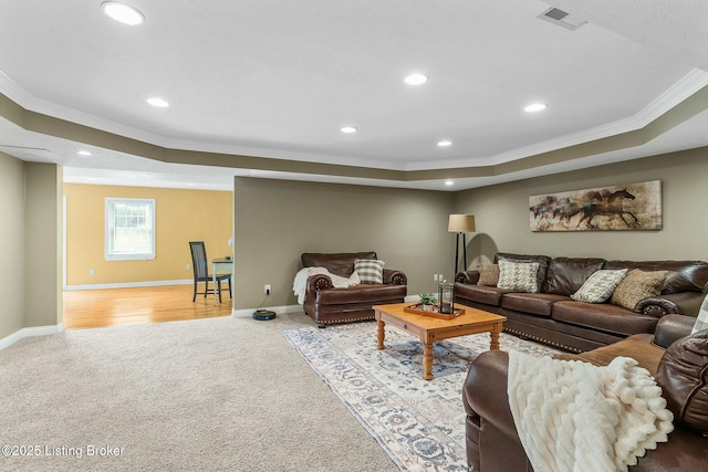 carpeted living area featuring ornamental molding, recessed lighting, visible vents, and a raised ceiling