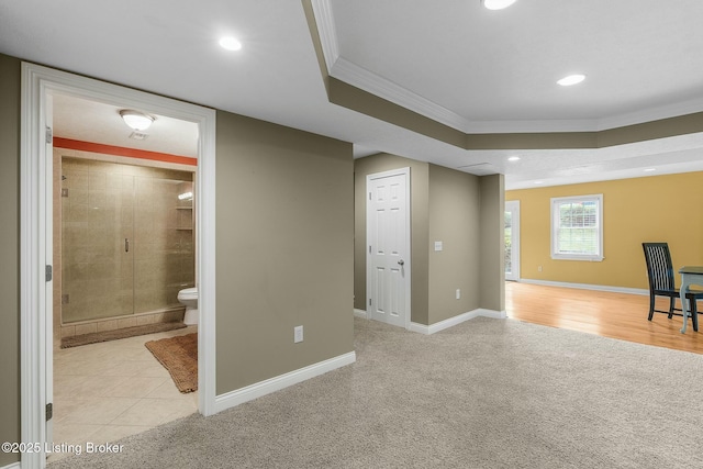 below grade area featuring baseboards, ornamental molding, recessed lighting, and light carpet