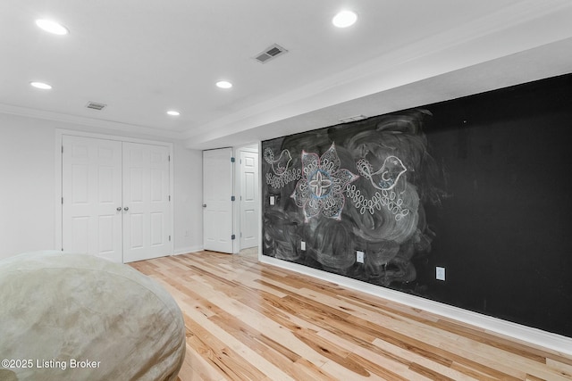 unfurnished bedroom with visible vents, wood finished floors, crown molding, and recessed lighting