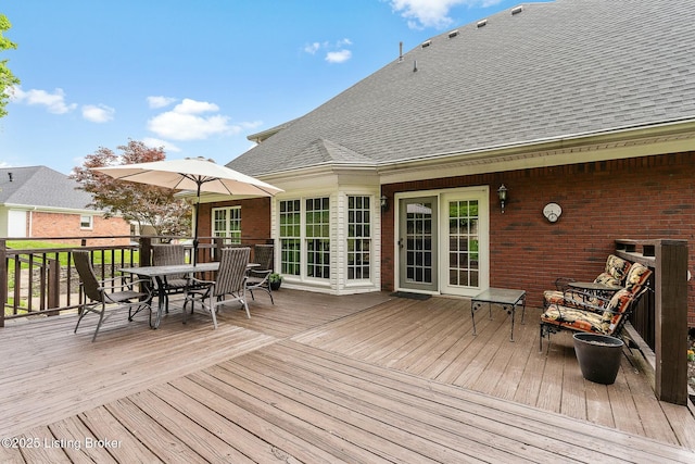 wooden terrace featuring outdoor dining space