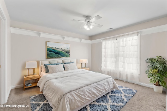 bedroom with visible vents, ceiling fan, light colored carpet, and baseboards