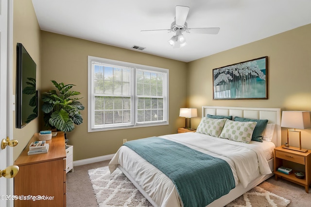 bedroom featuring baseboards, visible vents, a ceiling fan, and light carpet