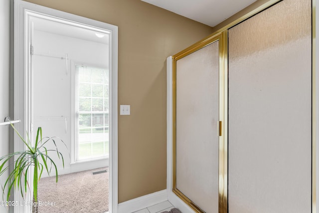 doorway to outside with baseboards and visible vents