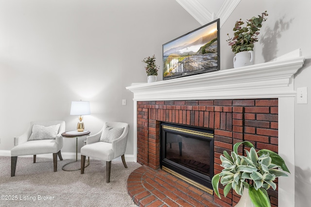 living area featuring carpet flooring, baseboards, crown molding, and a fireplace