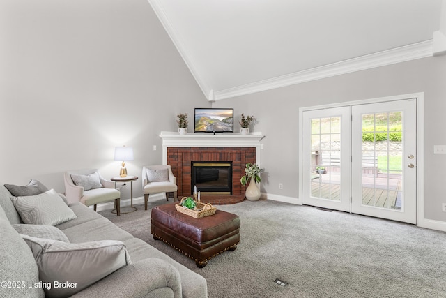 living area with ornamental molding, carpet flooring, a fireplace, baseboards, and lofted ceiling