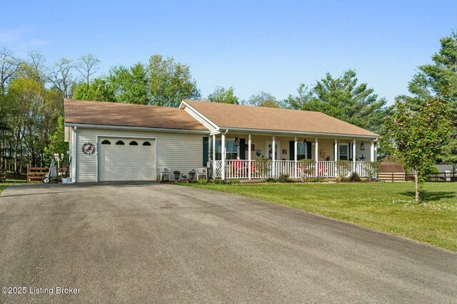 single story home with a front lawn, a garage, covered porch, and aphalt driveway