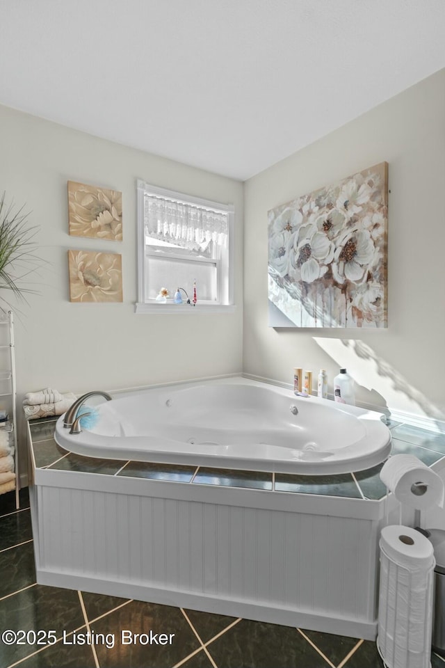 bathroom featuring a tub with jets and tile patterned flooring