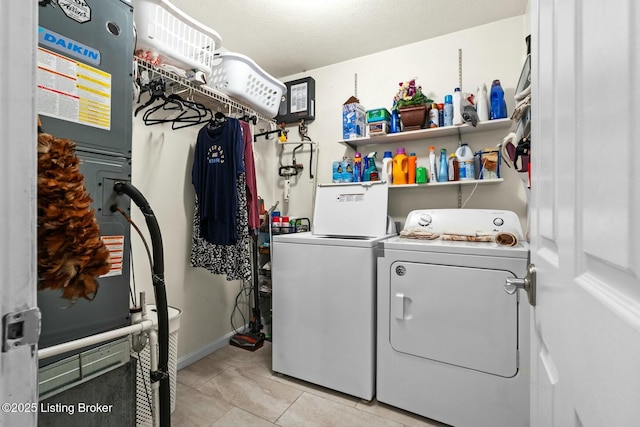 laundry room with washer and clothes dryer, light tile patterned floors, heating unit, and laundry area