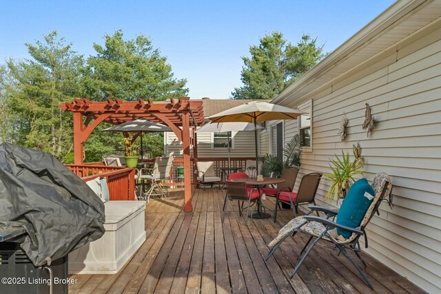 wooden terrace featuring outdoor dining space and a pergola