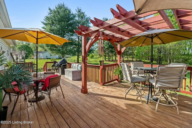 deck with a lawn, a pergola, and outdoor dining area
