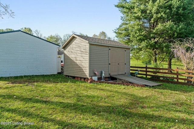 view of shed featuring fence