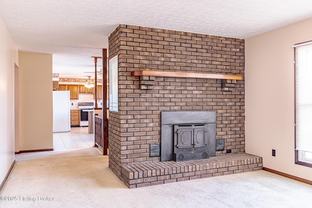 unfurnished living room with a wood stove, baseboards, a textured ceiling, and light colored carpet