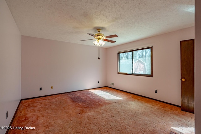 empty room featuring ceiling fan, baseboards, carpet flooring, and a textured ceiling