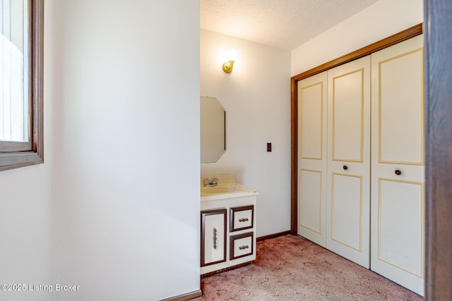 bathroom with vanity and a textured ceiling