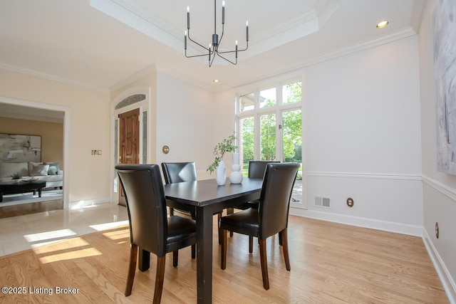 1038 Garden Creek Cir, Louisville, KY 40223 - dining room featuring a chandelier, light wood-style flooring, a raised ceiling, ornamental molding, and baseboards