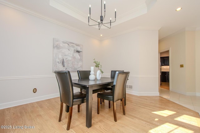1038 Garden Creek Cir, Louisville, KY 40223 - dining area featuring a chandelier, a raised ceiling, ornamental molding, light wood-style floors, and baseboards