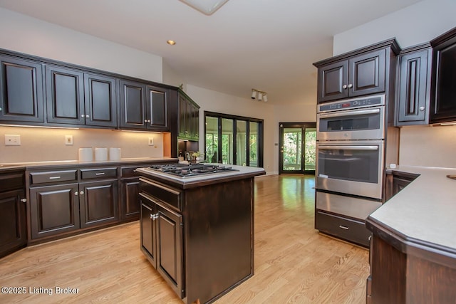 1038 Garden Creek Cir, Louisville, KY 40223 - kitchen with a warming drawer, appliances with stainless steel finishes, light wood-style floors, light countertops, and a kitchen island