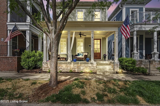 doorway to property with a ceiling fan and a porch