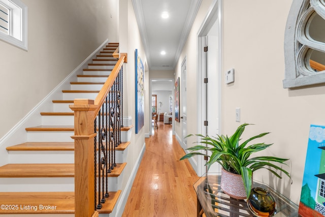 hallway with crown molding, stairs, recessed lighting, baseboards, and wood finished floors