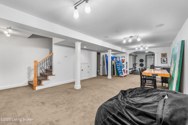 bedroom featuring arched walkways, baseboards, ornate columns, and carpet