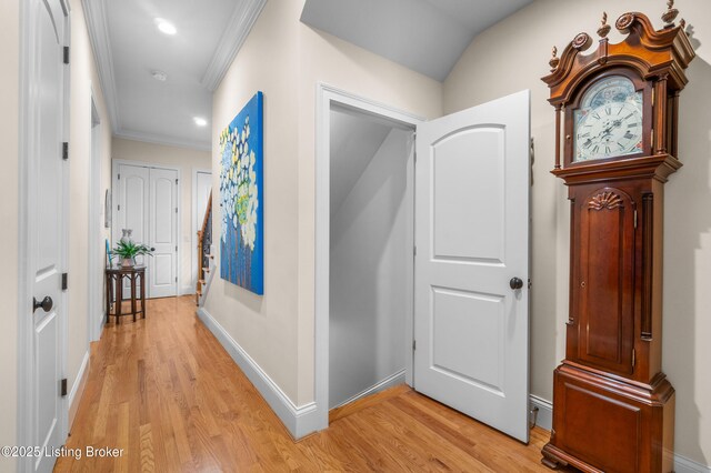 hall featuring recessed lighting, baseboards, ornamental molding, and light wood finished floors