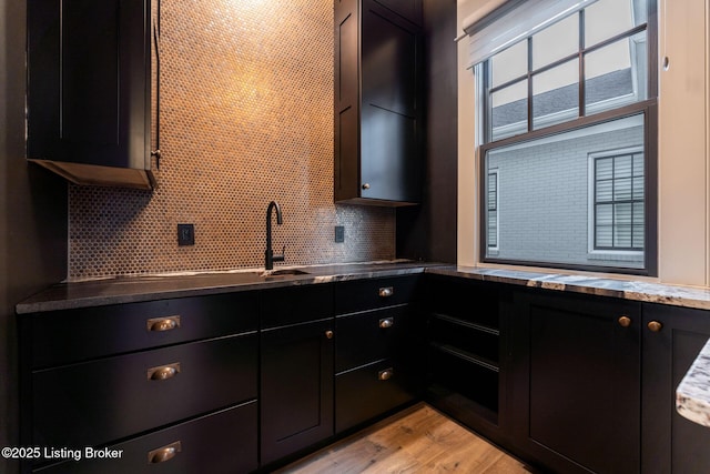 11004 Meeting St, Prospect, KY 40059 - kitchen with a sink, dark cabinetry, decorative backsplash, and light wood-style floors