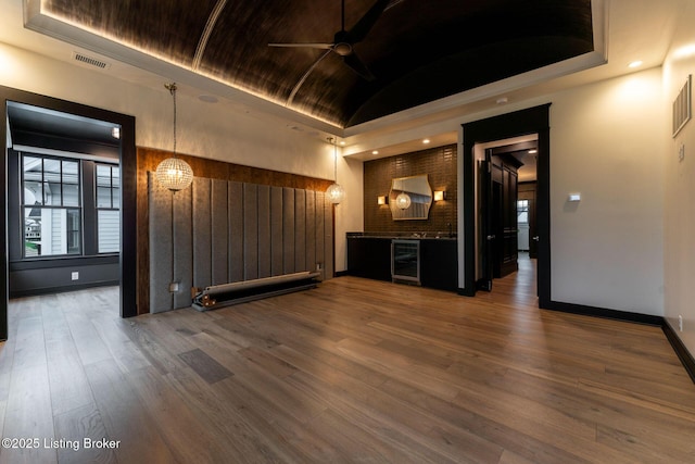 11004 Meeting St, Prospect, KY 40059 - unfurnished living room featuring wine cooler, ceiling fan, lofted ceiling, wood finished floors, and baseboards