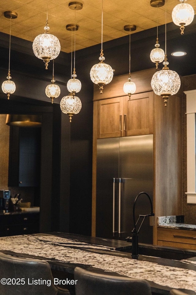 11004 Meeting St, Prospect, KY 40059 - kitchen with high end refrigerator, brown cabinetry, and pendant lighting