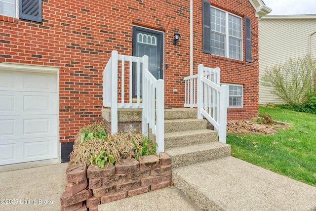 doorway to property featuring brick siding and a garage