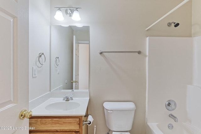 bathroom featuring toilet, shower / washtub combination, and vanity