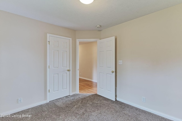 unfurnished bedroom featuring carpet floors and baseboards