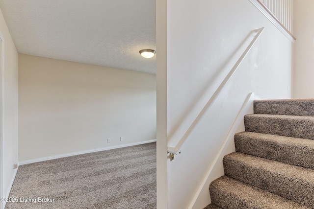 staircase with carpet flooring and baseboards