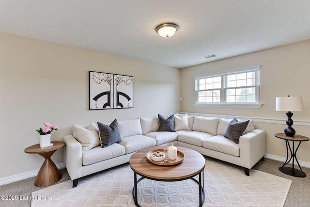 living room featuring baseboards, visible vents, and light colored carpet