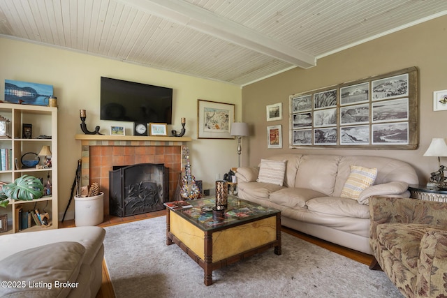 living room with beam ceiling, wood ceiling, wood finished floors, and a fireplace