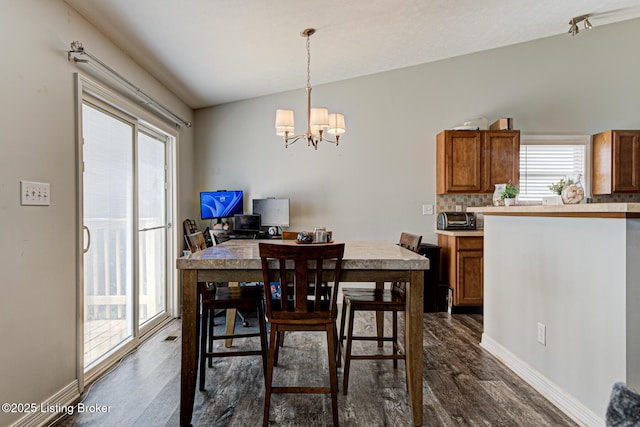 5416 Bannon Crossings Dr, Louisville, KY 40218 - dining room with dark wood finished floors, plenty of natural light, and an inviting chandelier