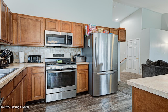 5416 Bannon Crossings Dr, Louisville, KY 40218 - kitchen featuring light countertops, backsplash, and appliances with stainless steel finishes
