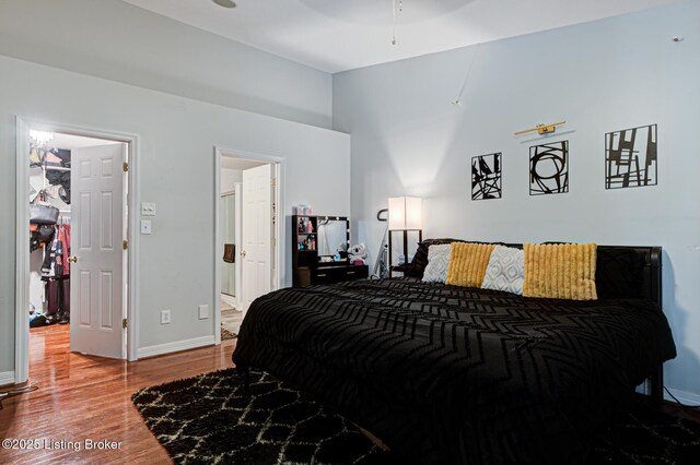 5416 Bannon Crossings Dr, Louisville, KY 40218 - bedroom with wood finished floors, ensuite bath, and baseboards