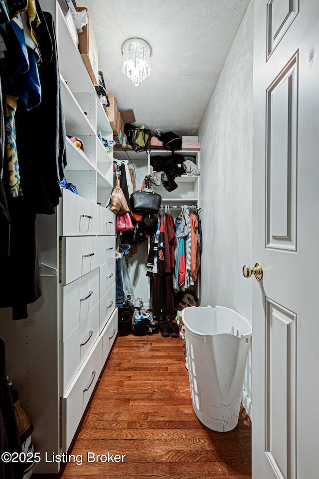 5416 Bannon Crossings Dr, Louisville, KY 40218 - walk in closet with wood finished floors and an inviting chandelier