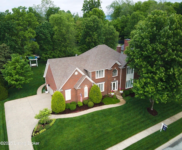 1304 Isleworth Dr, Louisville, KY 40245 - colonial home featuring driveway, brick siding, a shingled roof, a chimney, and a front yard