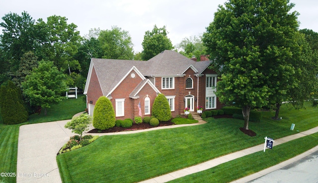 1304 Isleworth Dr, Louisville, KY 40245 - colonial inspired home with driveway, brick siding, a front yard, and a garage