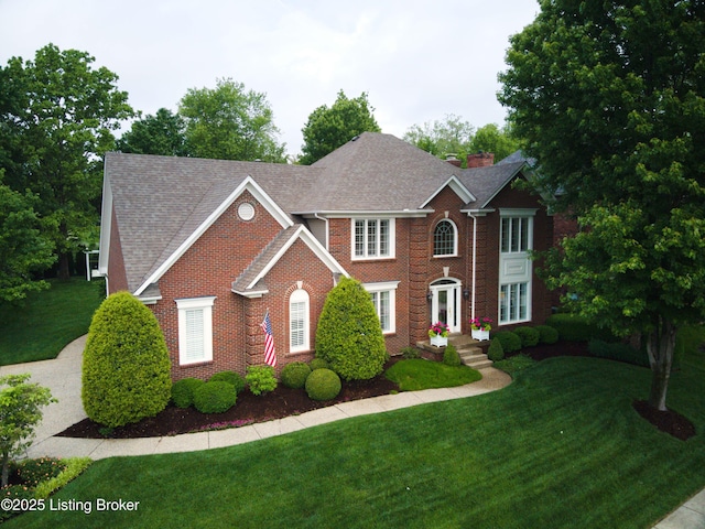 1304 Isleworth Dr, Louisville, KY 40245 - view of front of house featuring brick siding, a front yard, and roof with shingles