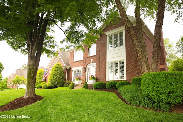 1304 Isleworth Dr, Louisville, KY 40245 - colonial house featuring a front yard and brick siding