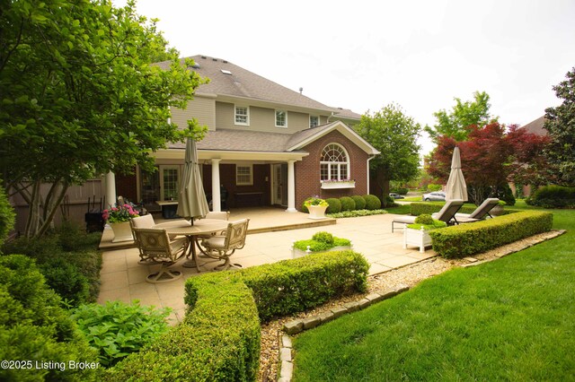 1304 Isleworth Dr, Louisville, KY 40245 - rear view of property featuring a patio, a yard, and roof with shingles