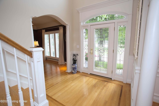 1304 Isleworth Dr, Louisville, KY 40245 - entryway featuring wood finished floors, a decorative wall, a wainscoted wall, ornate columns, and stairway