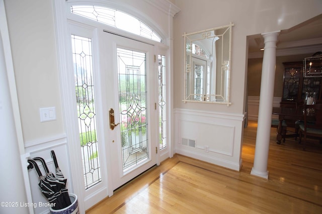 1304 Isleworth Dr, Louisville, KY 40245 - entryway featuring ornate columns, light wood-style floors, and a wainscoted wall